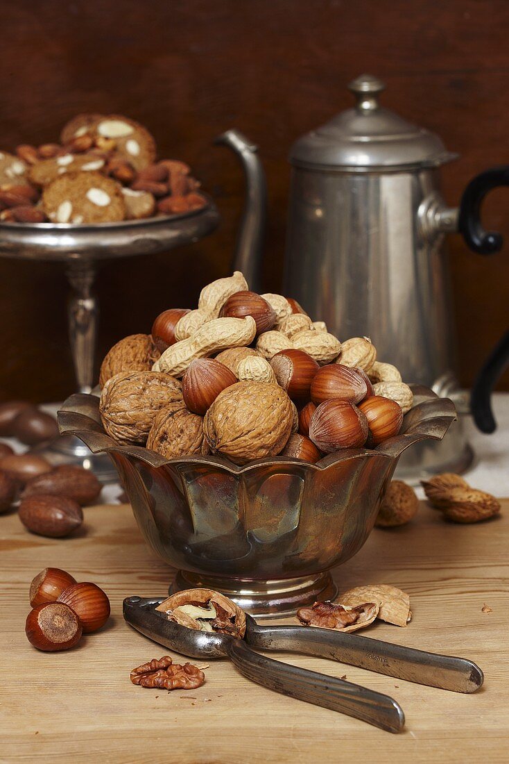 Nut still life with nutcracker and biscuits