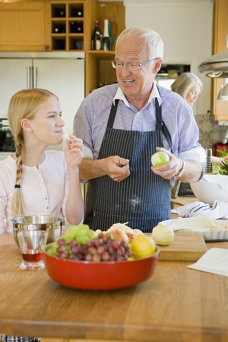 Girl baking with grandparents