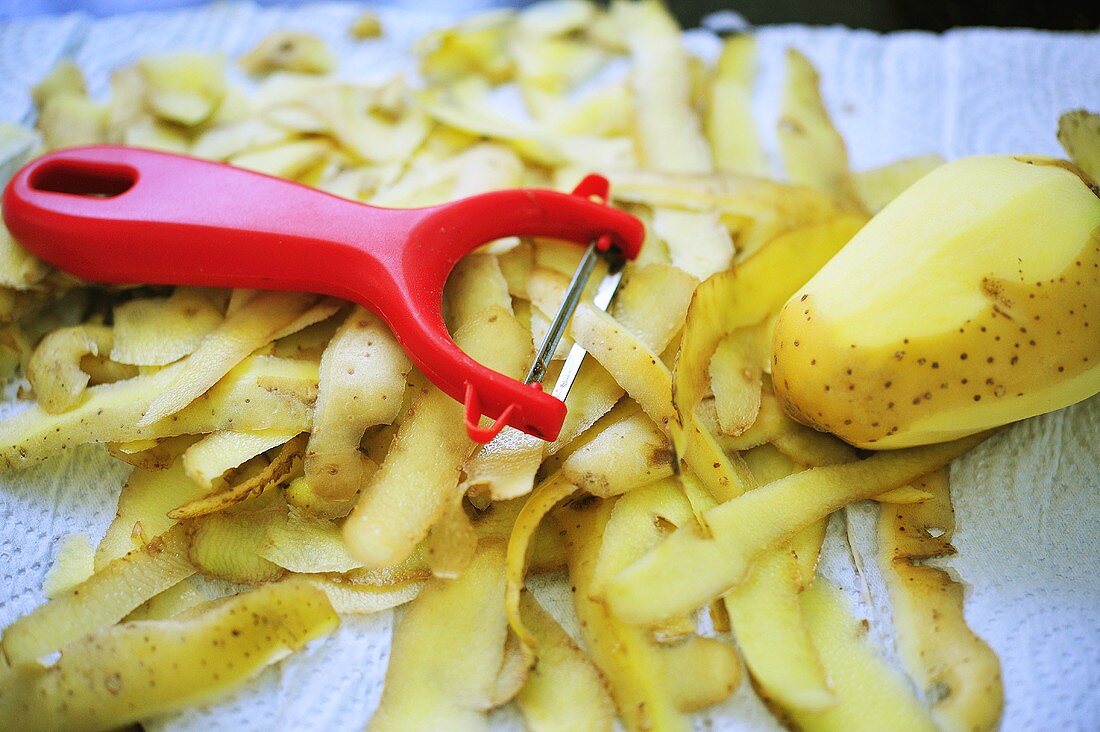 Potato peeler with potato peelings and potato
