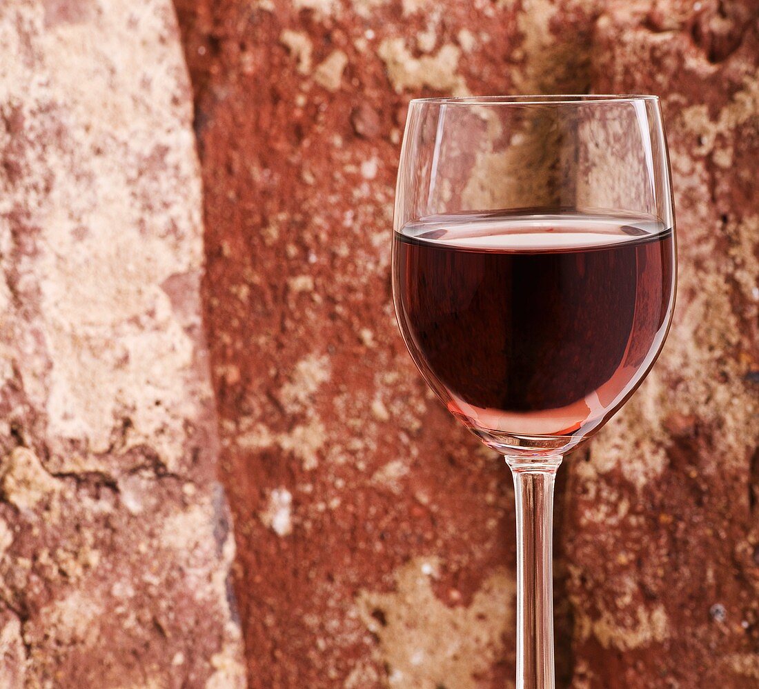 Glass of rosé wine against brick background