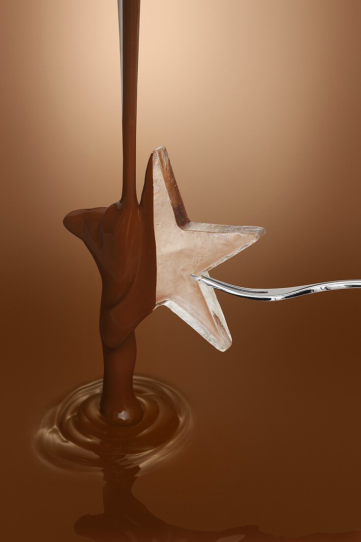 Pouring melted chocolate over ice star