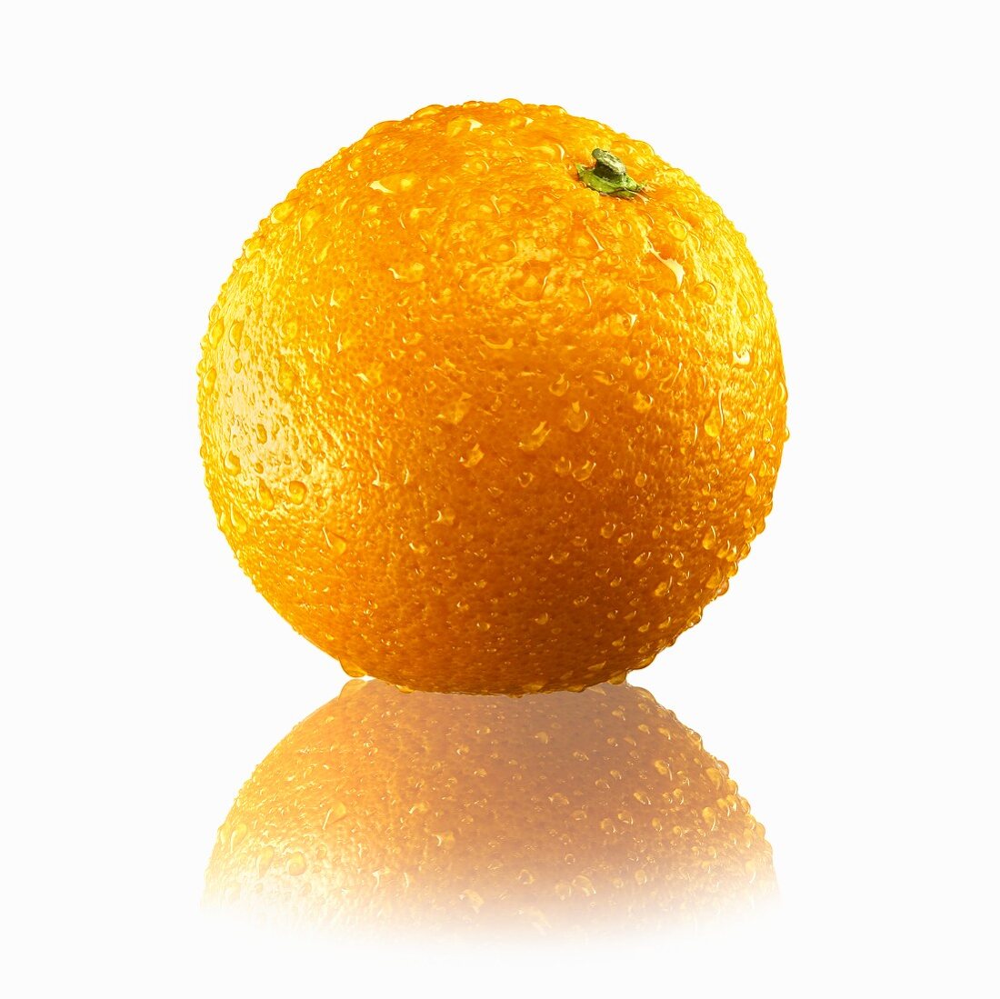 A whole orange with drops of water