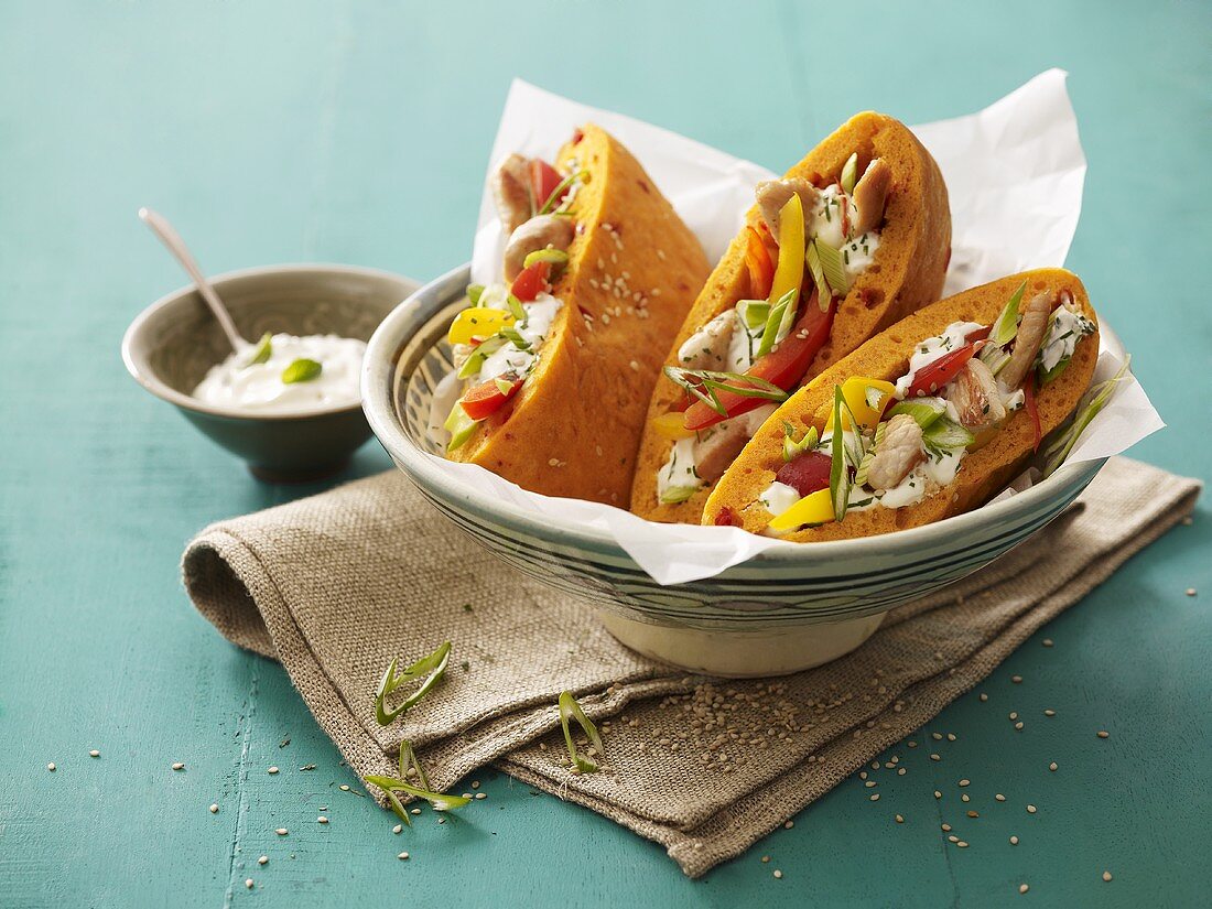 Filled flatbreads in dish, sour cream beside it