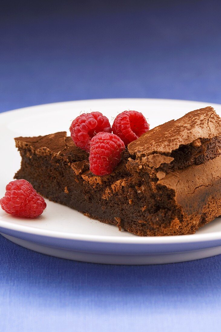 Piece of (flourless) chocolate cake with raspberries