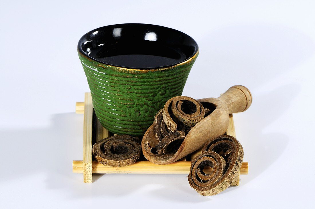 Magnolia bark with a bowl of tea