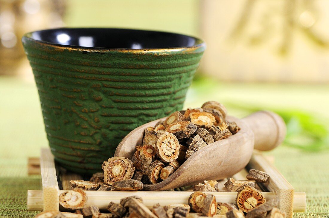 Saposhnikovia root in tea strainer, bowl of tea