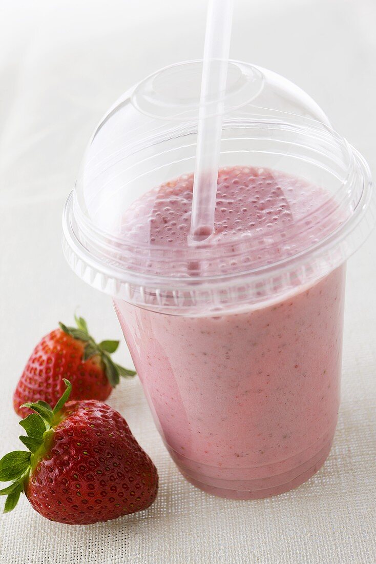 A strawberry shake in plastic take-away … – License Images – 997799 ❘  StockFood