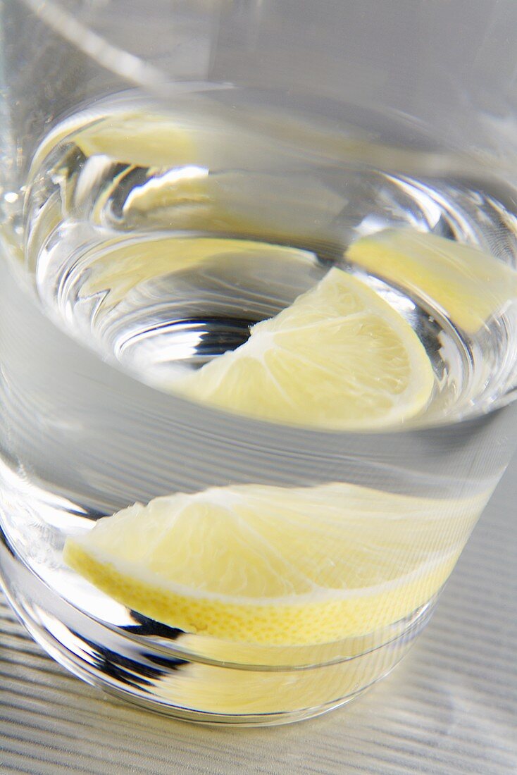 Glass of water with slice of lemon (close-up)
