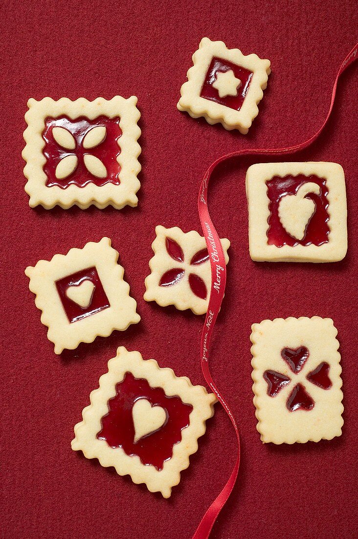 Seven square jam biscuits with red ribbon