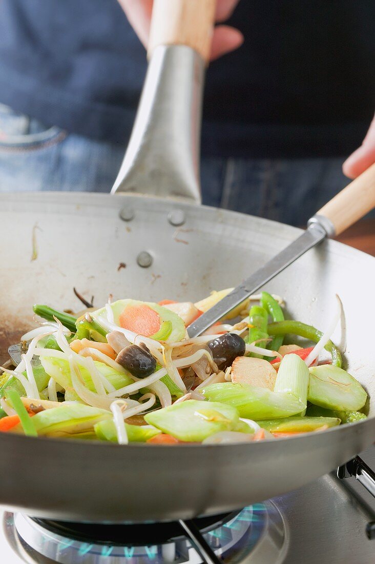 Frying Asian vegetables in frying pan