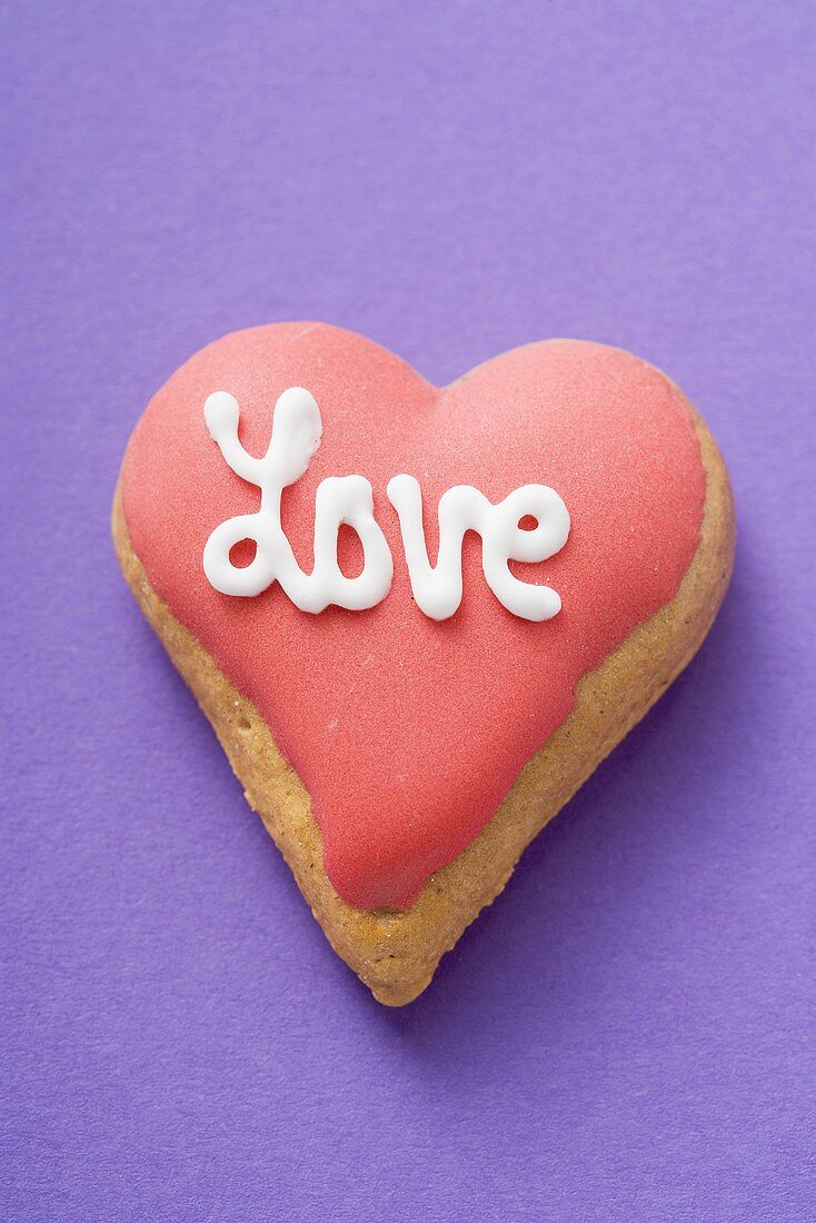 Heart-shaped biscuit with the word Love for Valentine's Day