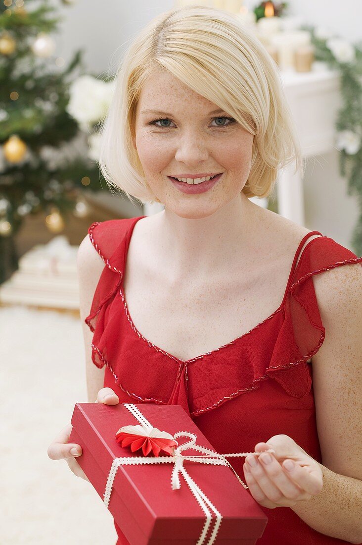Woman opening Christmas parcel