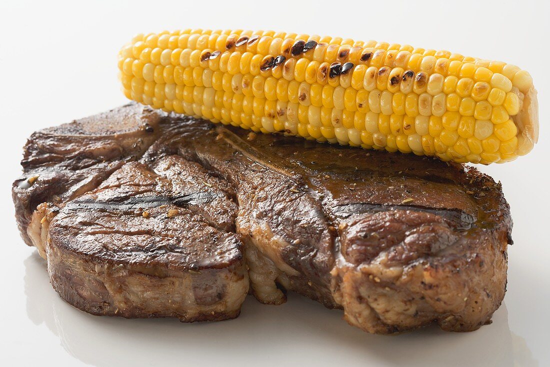 Grilled beef steak with corn on the cob