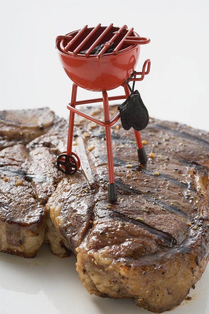 Grilled T-bone steak with toy barbecue