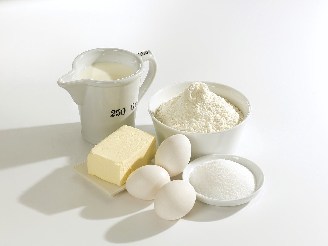 Various baking ingredients: butter, eggs, sugar, flour, milk