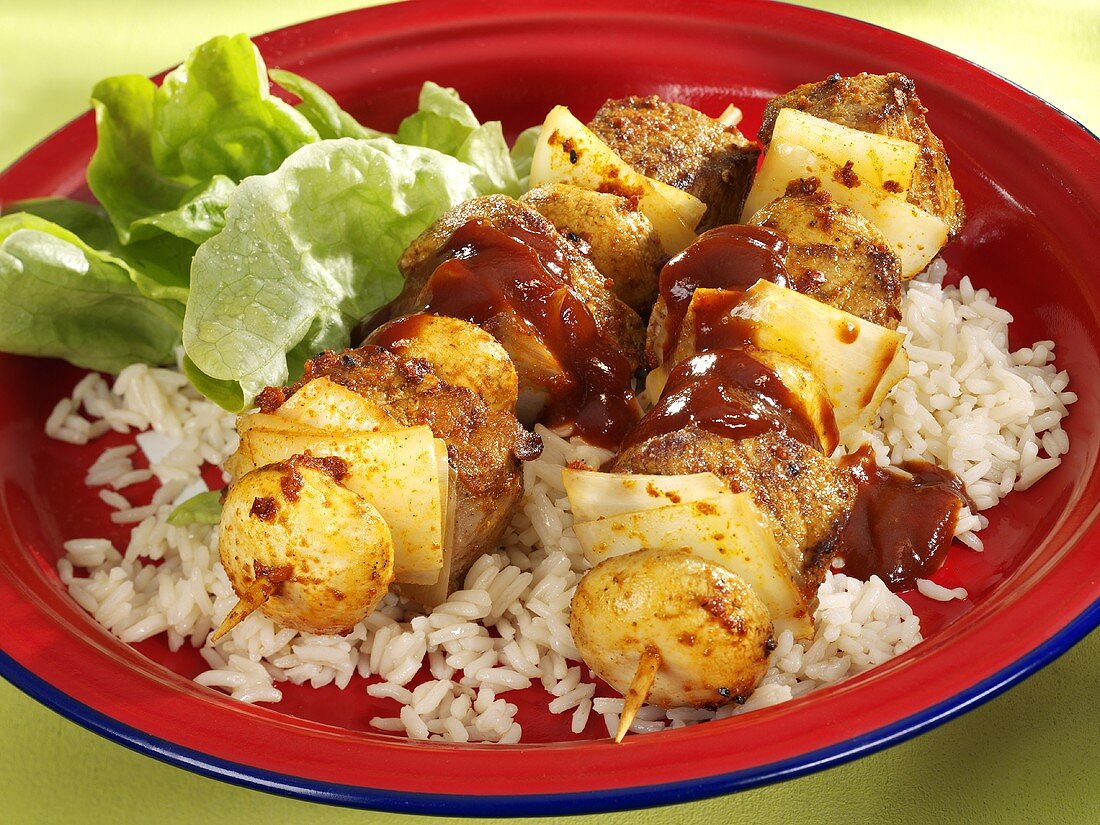 Veal and onion kebabs on rice