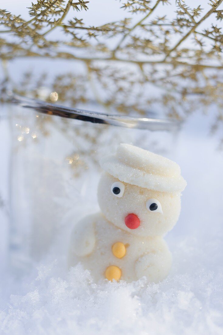Small marzipan snowman in snow