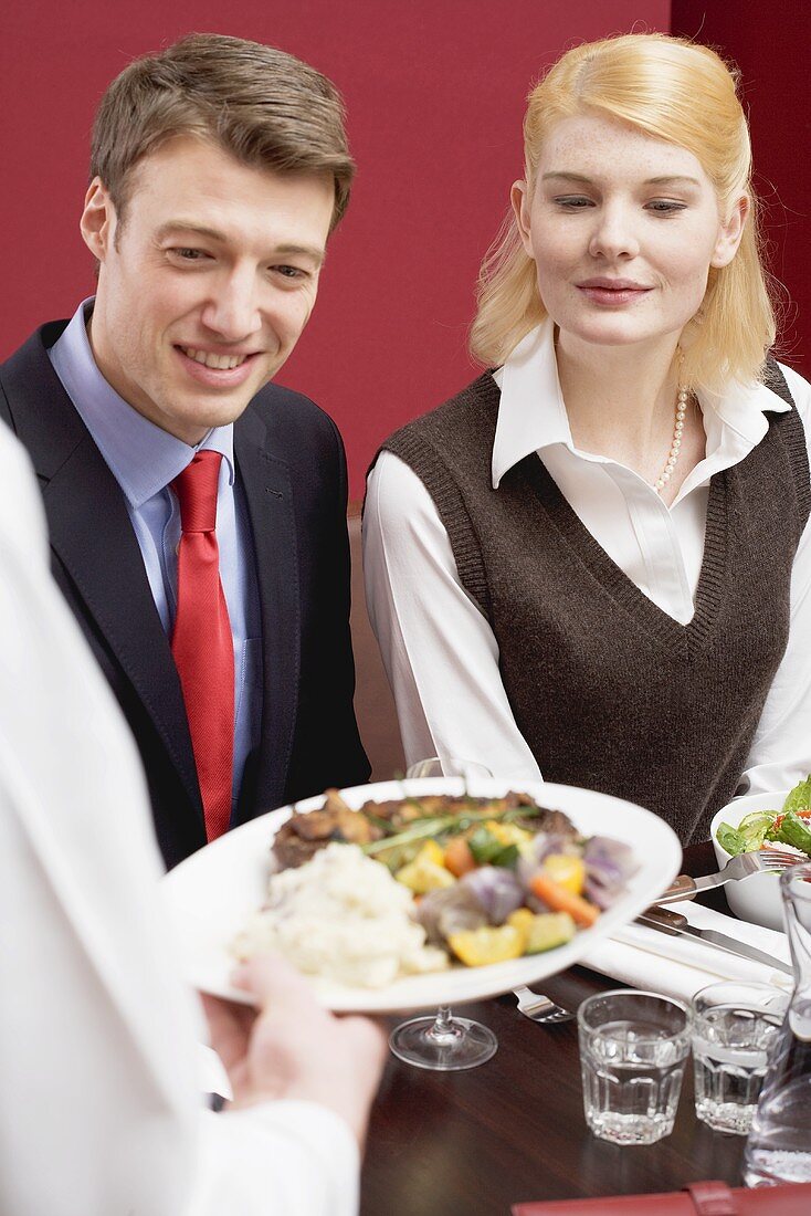 Person serving lunch to office colleagues