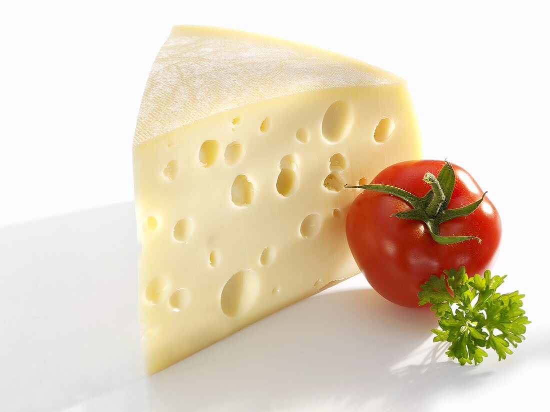 Piece of Emmental cheese, tomato and parsley
