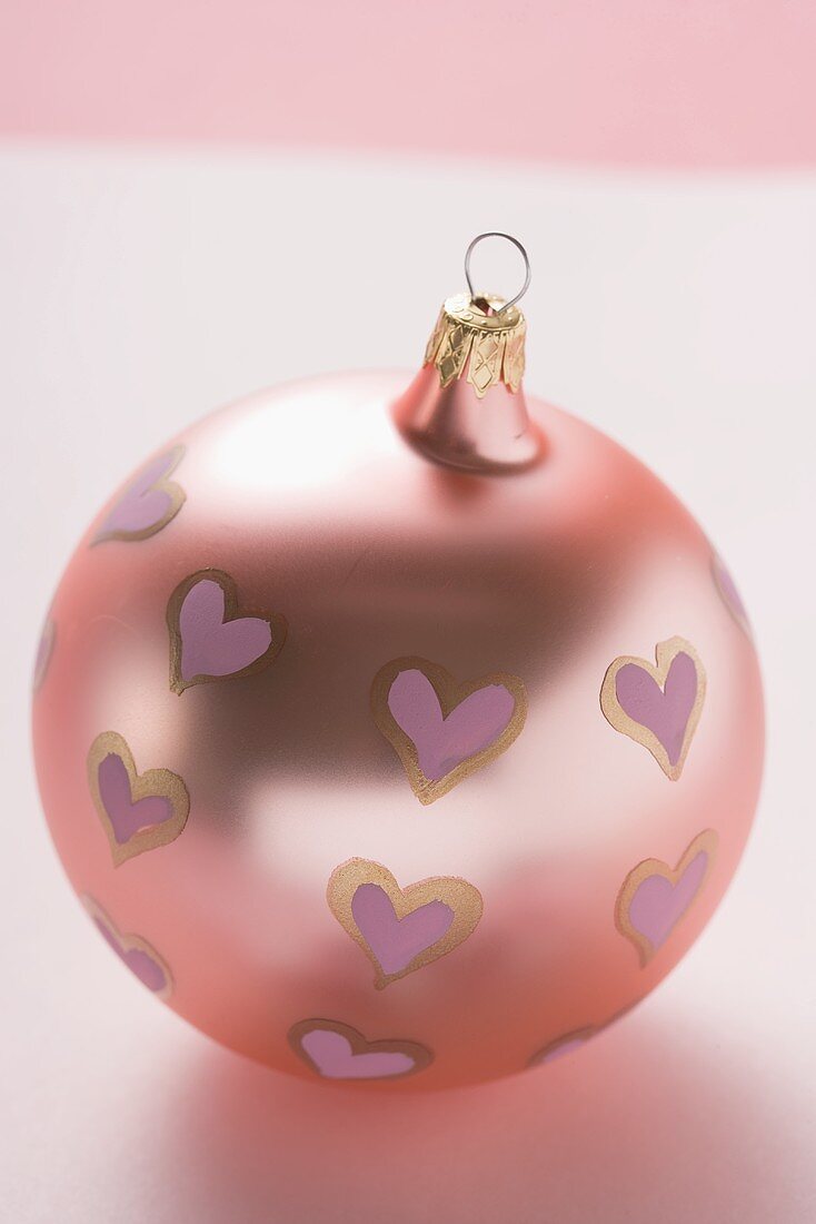 Pink Christmas bauble with painted hearts