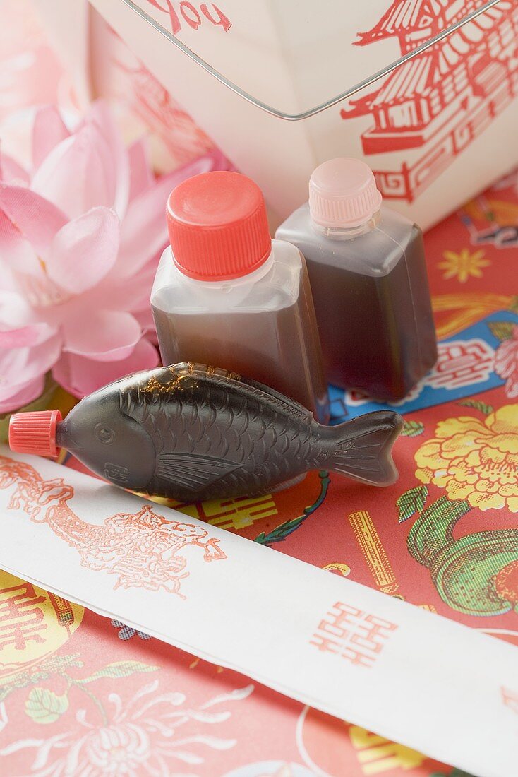 Soy sauce, chopsticks and take-away container (Asia)