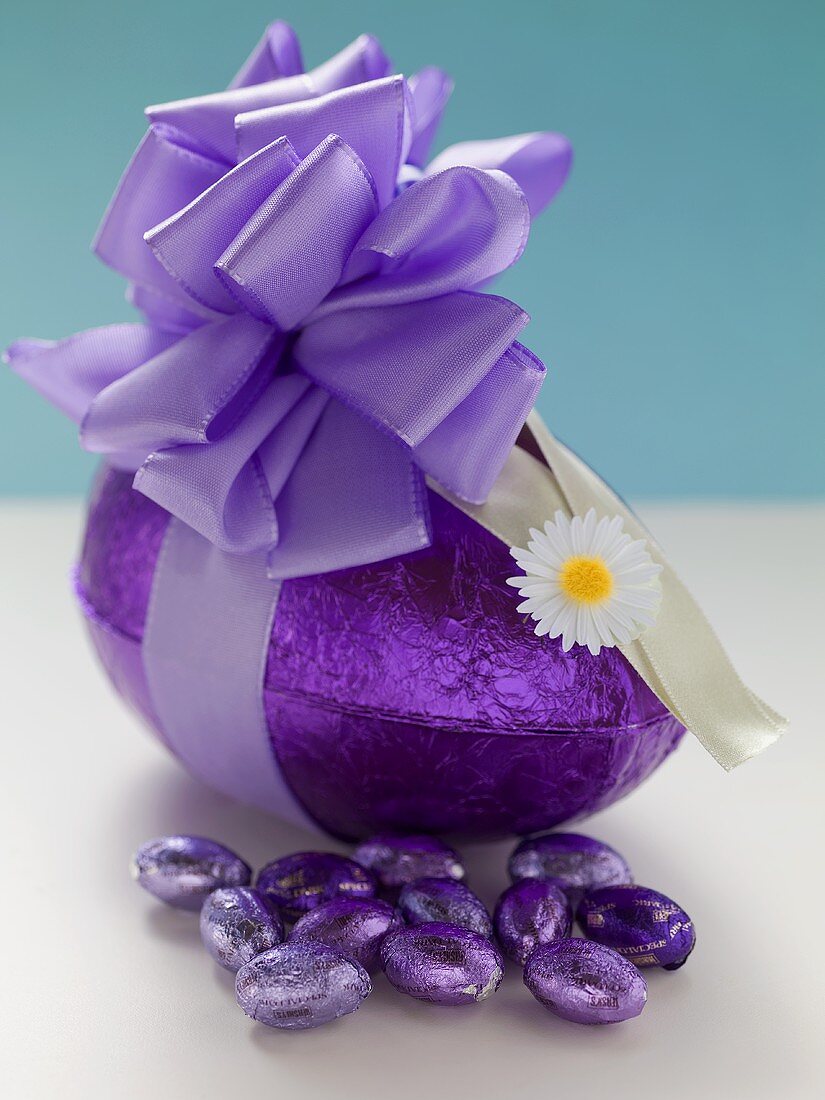 Chocolate Easter eggs in purple foil, one with bow