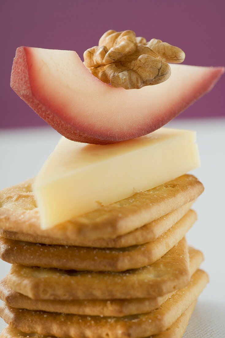 Piece of Emmental cheese, red wine pear & walnut on crackers
