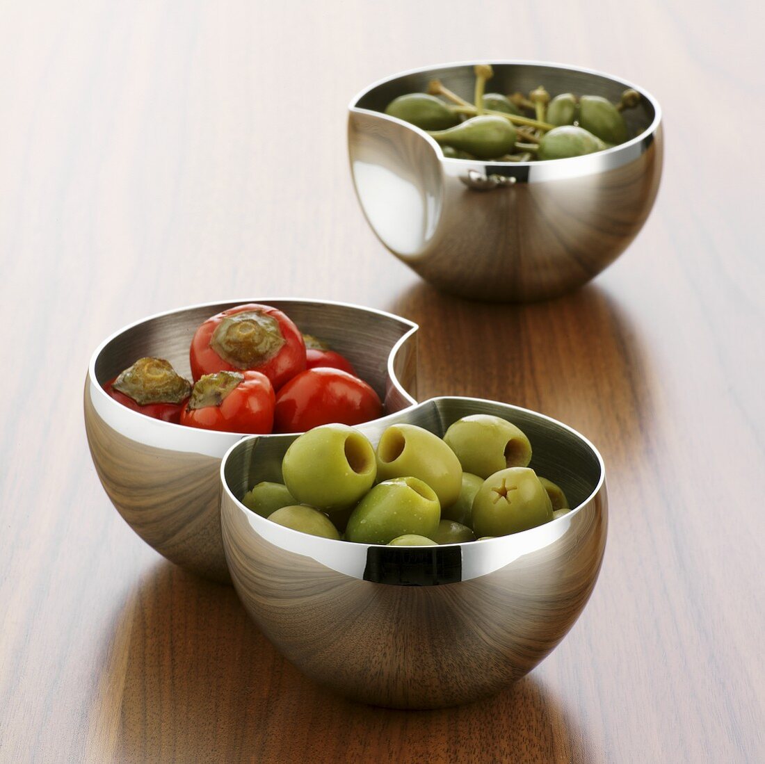 Chillies, giant capers and olives in small bowls