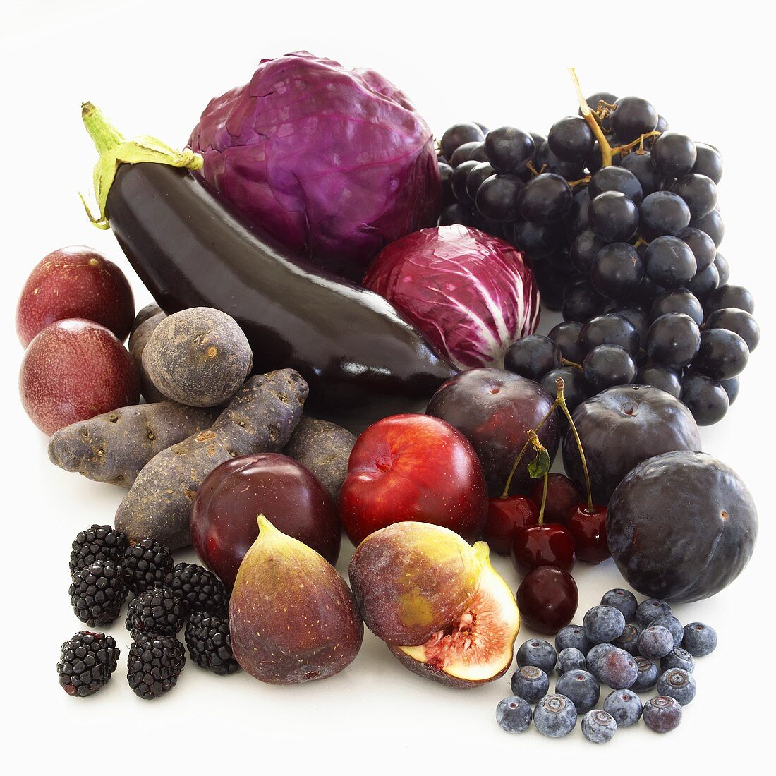 Still life with purple fruit and vegetables