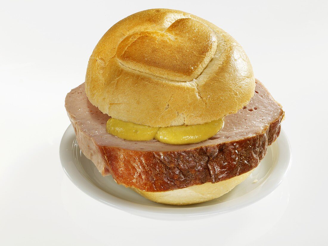 Slice of Leberkäse (type of meatloaf) in bread roll with heart