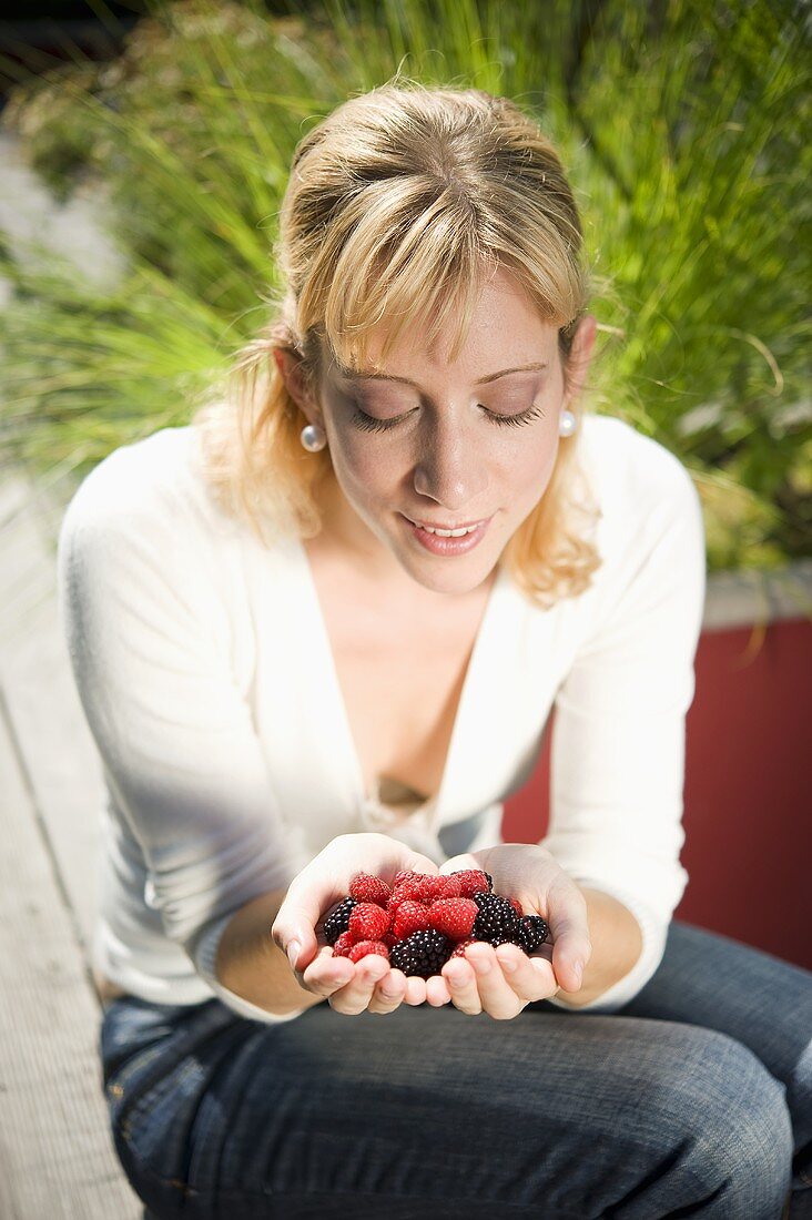 Woman holding fresh berries in her hands