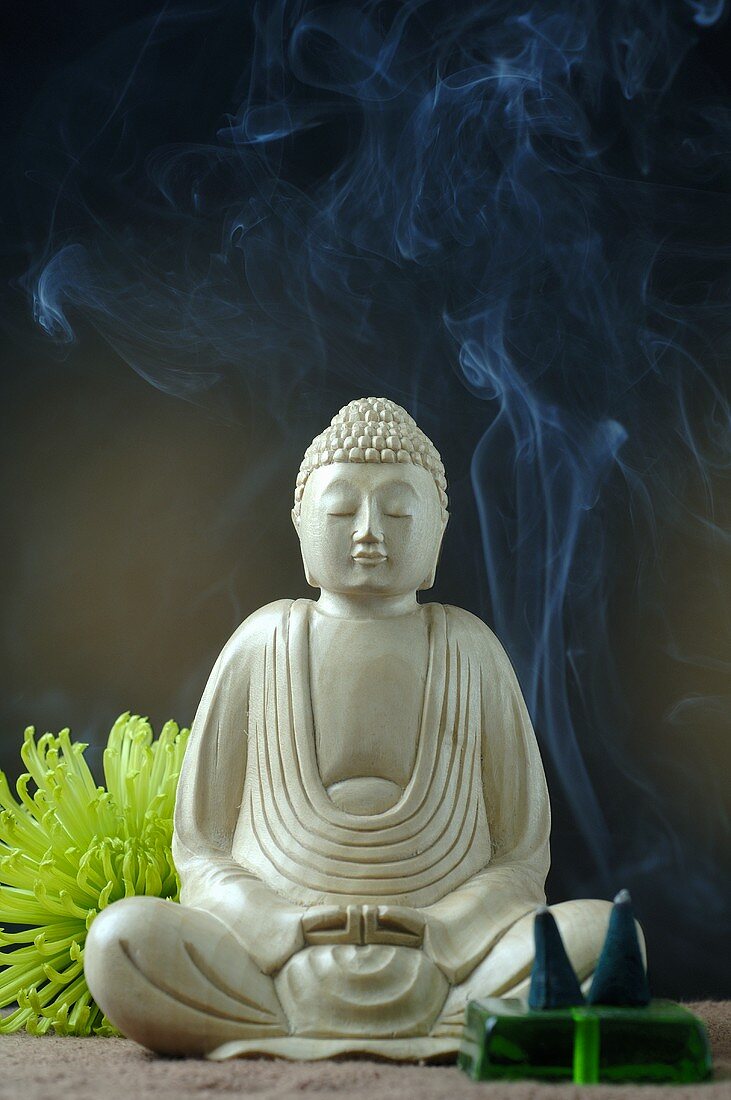 Buddha figure with incense sticks