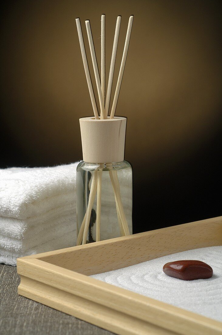 Scented oil, towels and healing stone