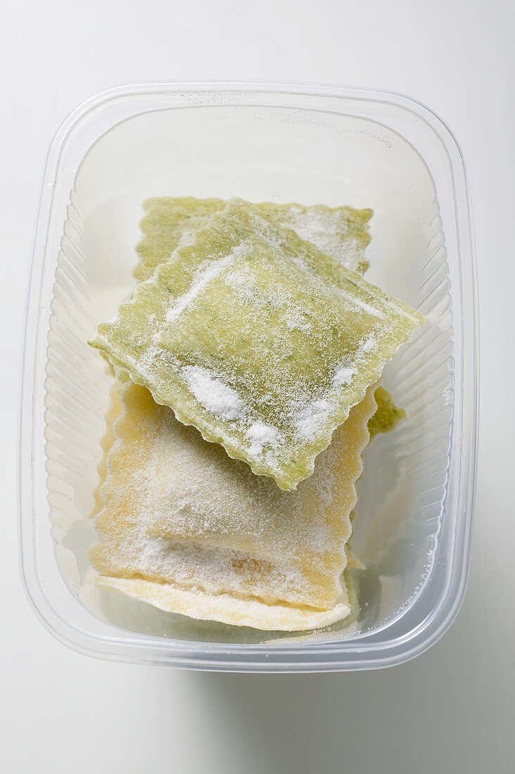 Home-made ravioli in plastic container (overhead view)