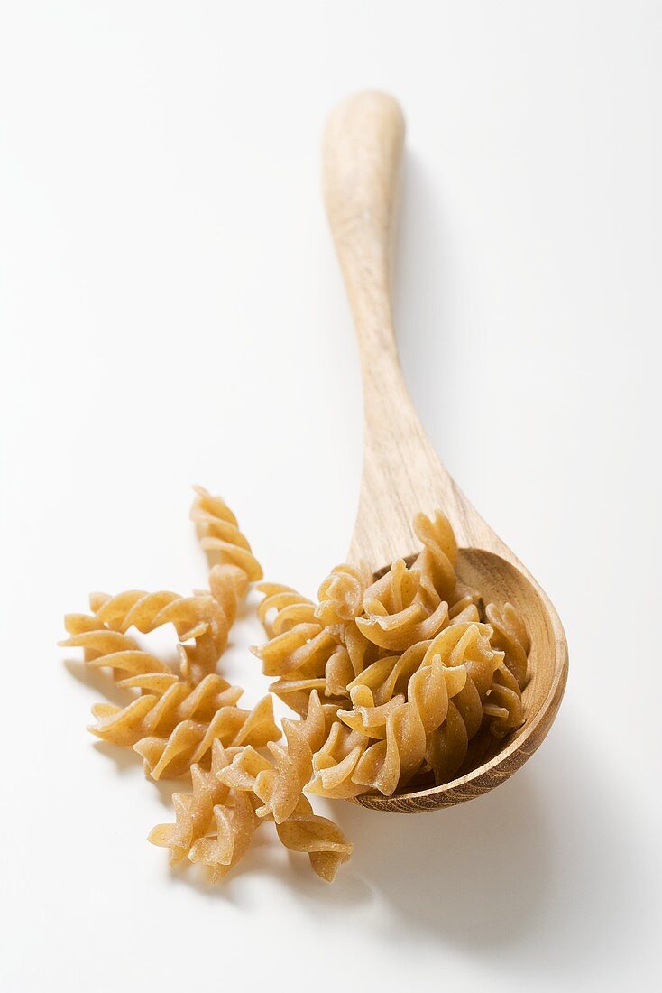 Wholemeal fusilli with wooden spoon