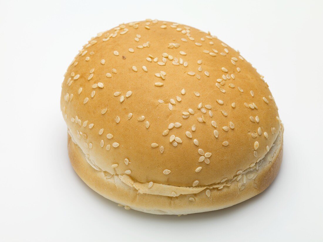 A hamburger bun with sesame seeds