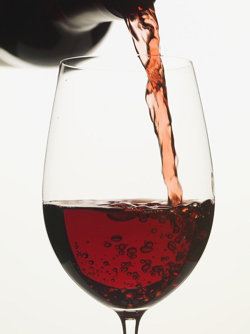 Pouring red wine into a glass