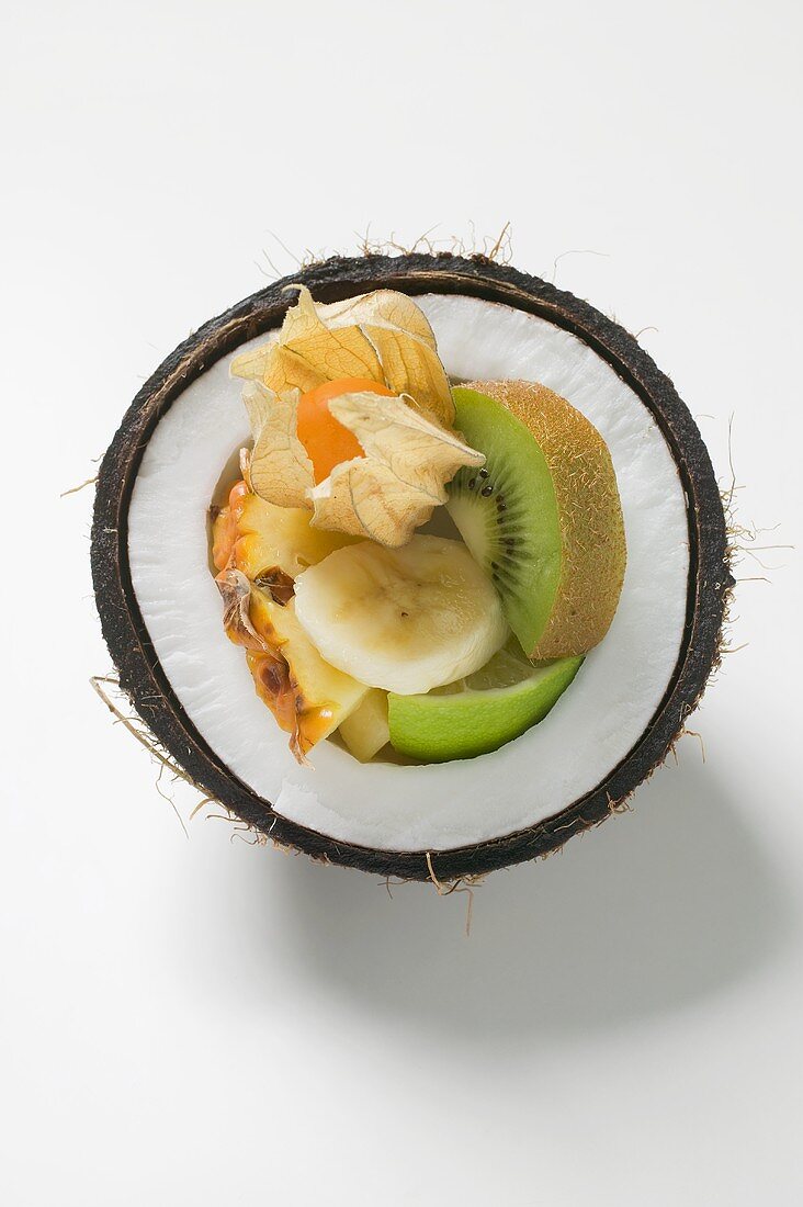 Fresh exotic fruit in half a coconut