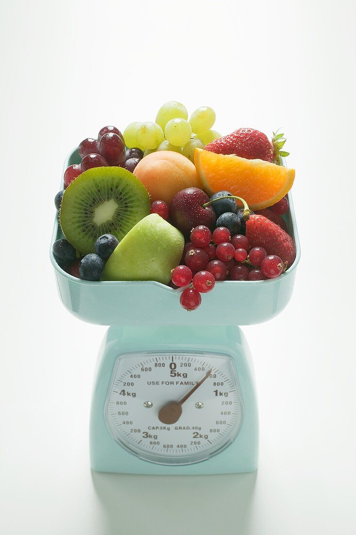 Fresh fruit on kitchen scales