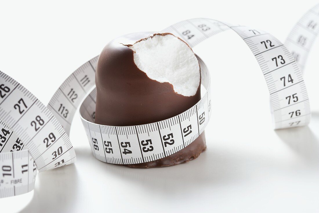 Chocolate-coated marshmallow treat with tape measure