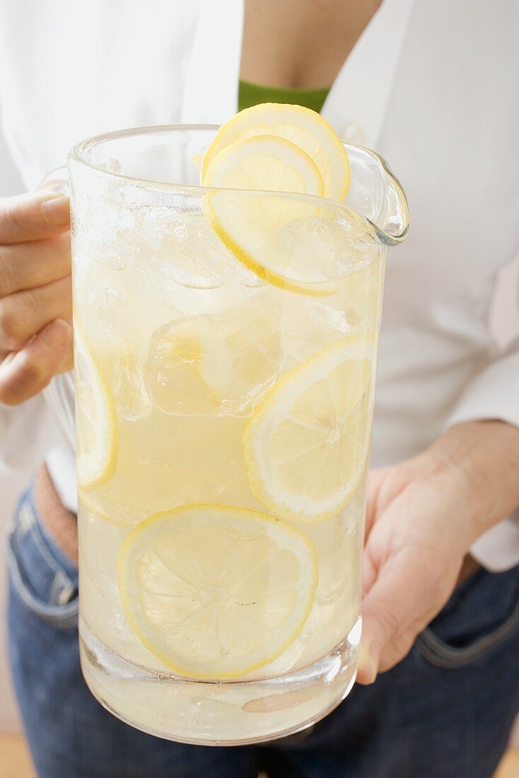 Woman holding a jug of lemonade