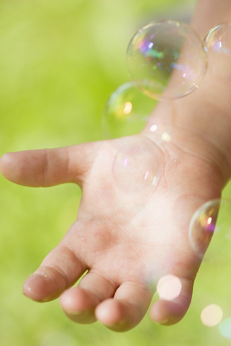Child's hand with bubbles