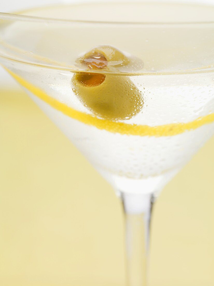 Martini with olive and lemon zest (close-up)