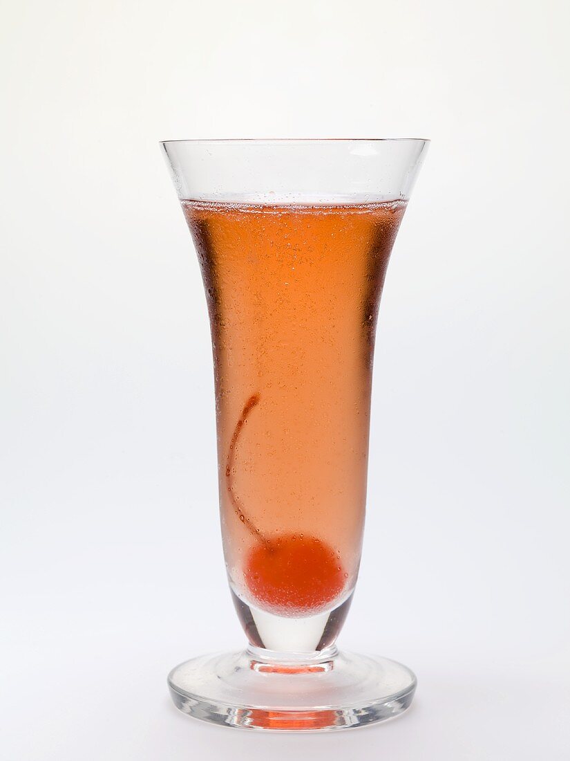 Sparkling wine cocktail with cocktail cherry