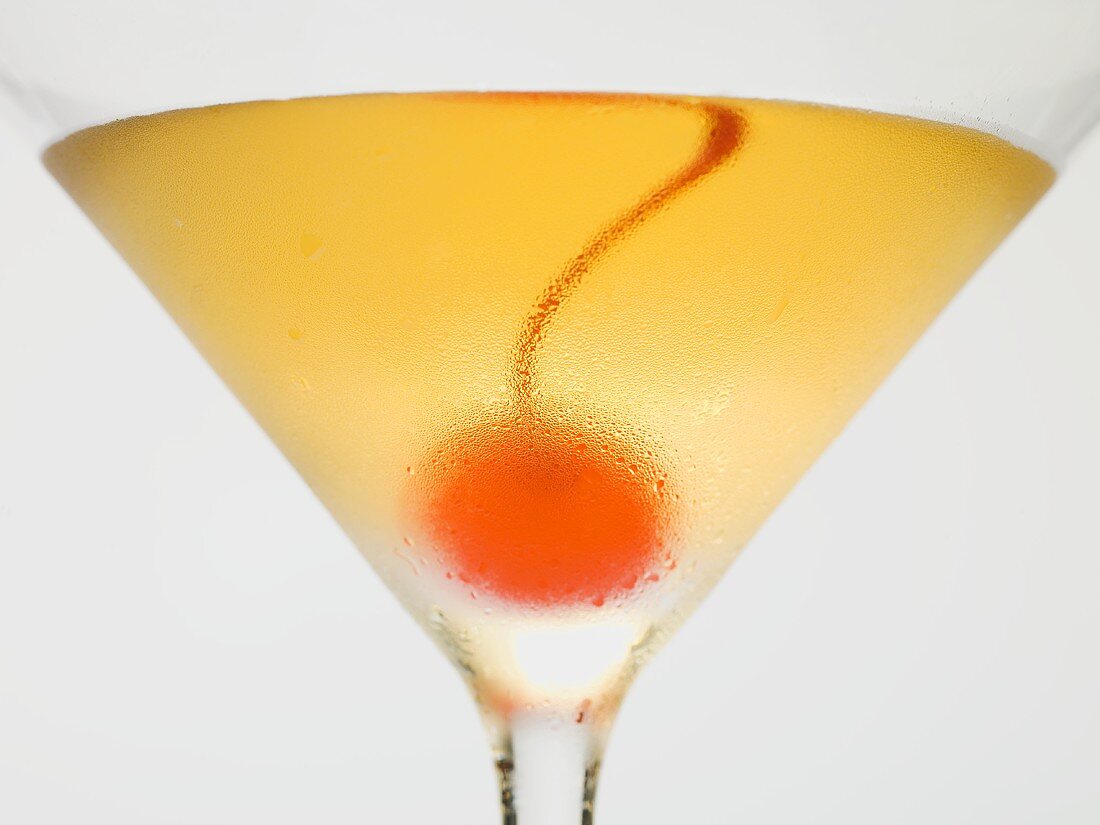 Manhattan with cocktail cherry (close-up)