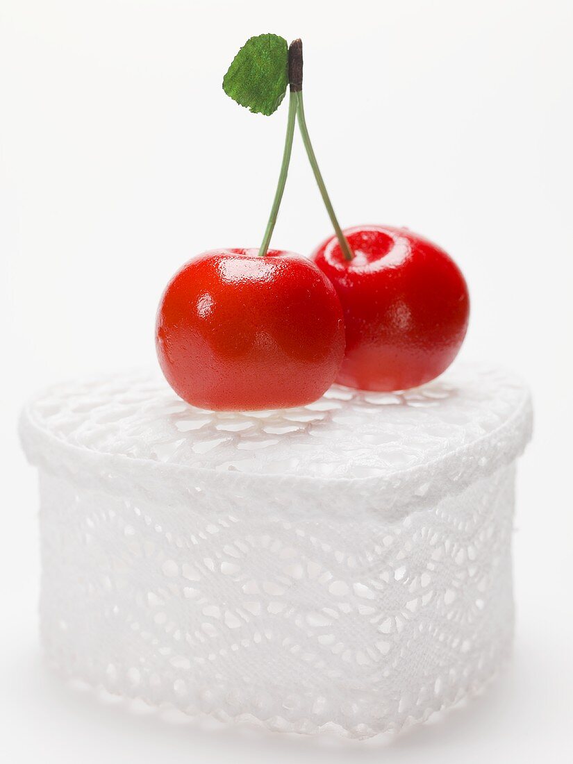 Marzipan cherries on heart-shaped gift box