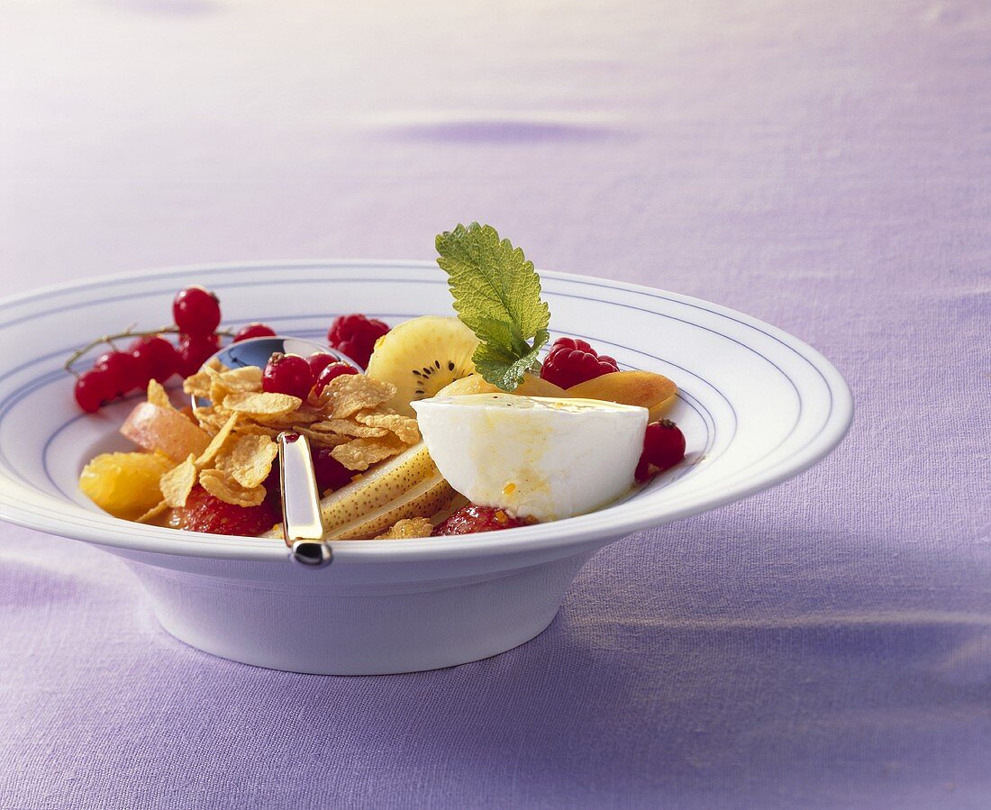 Fruit salad with yoghurt and cornflakes
