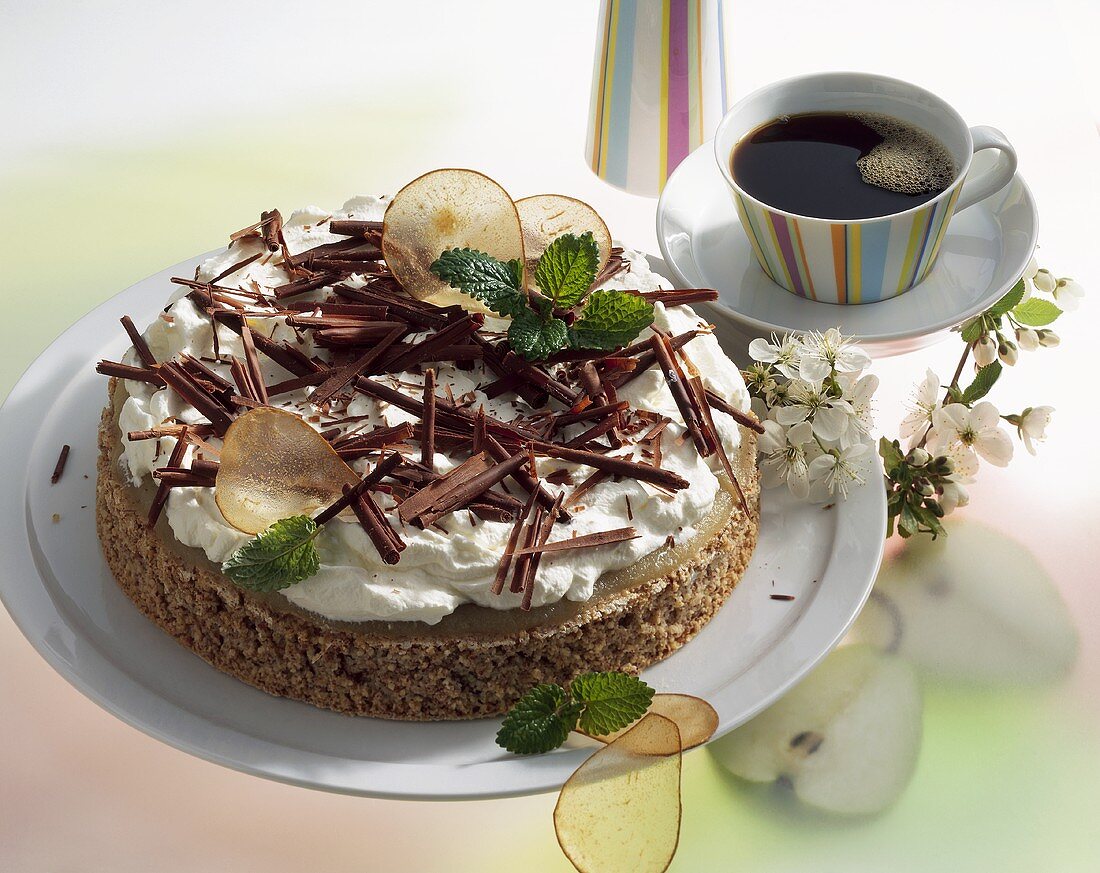 Almond cake with pears, whipped cream and chocolate shavings