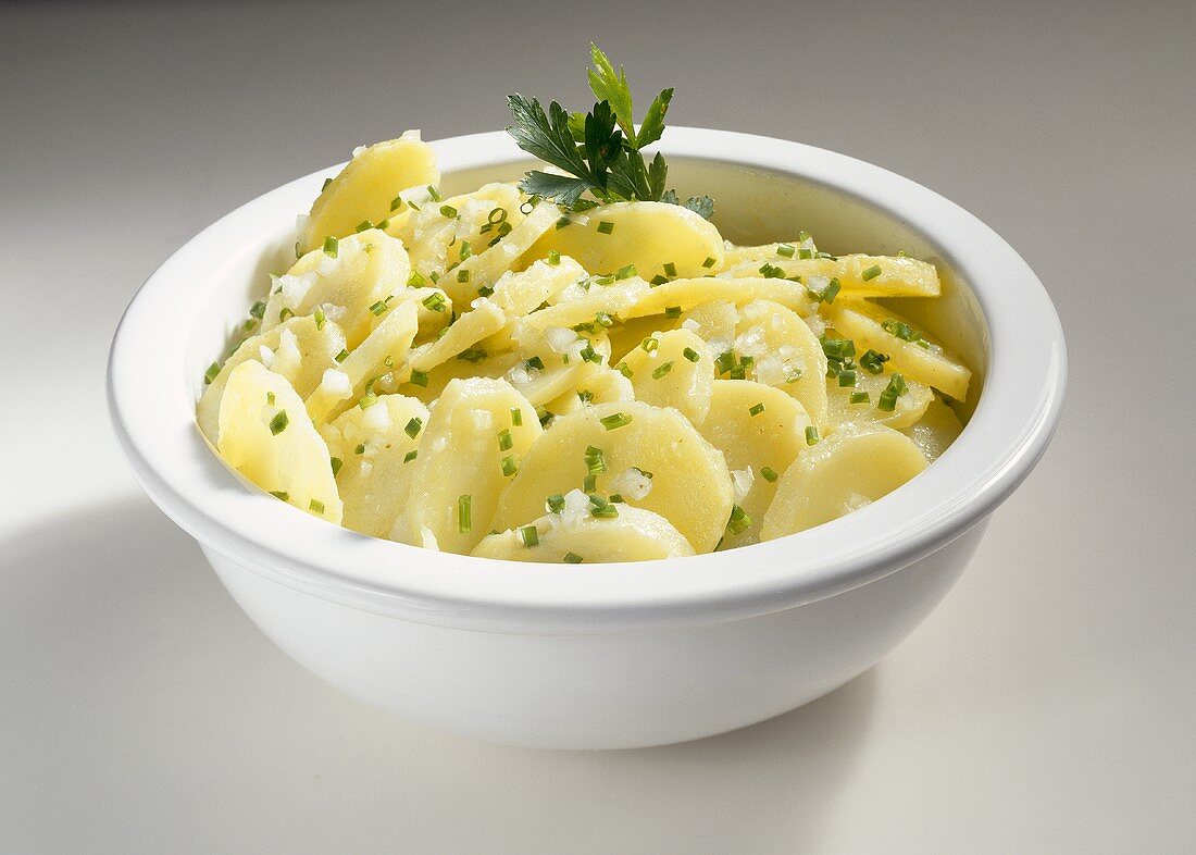 A bowl of potato salad with chives