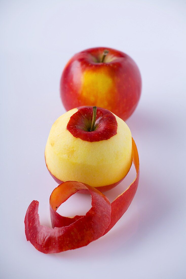 Two apples, one partly peeled